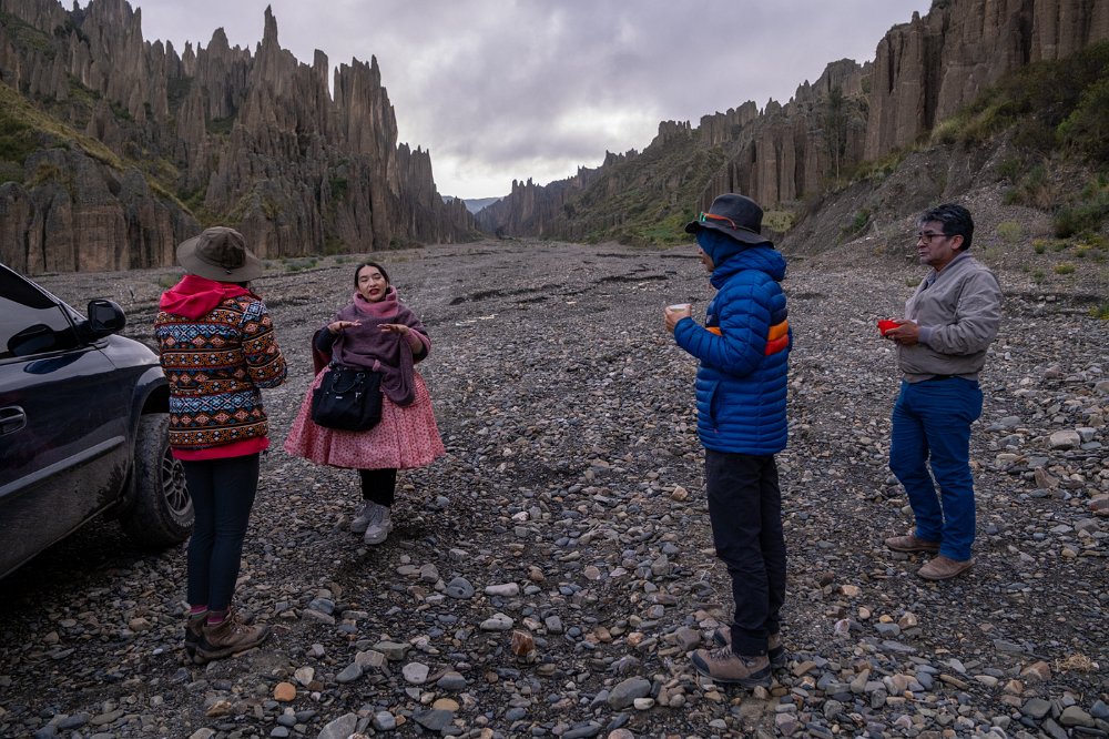 Aracely guiding guests in a rocky canyon landscape outside La Paz.